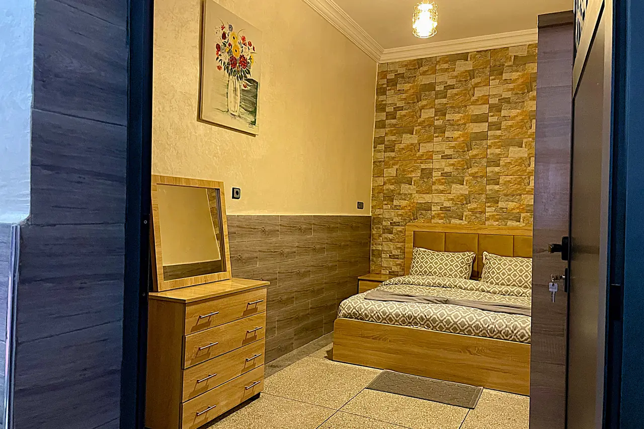 Bedroom with handmade Moroccan pendant lantern and wooden dresser