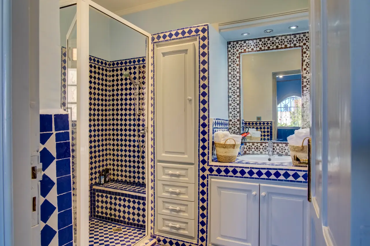 Salle de bain authentique en zellige marocain bleu et blanc avec douche et vasque