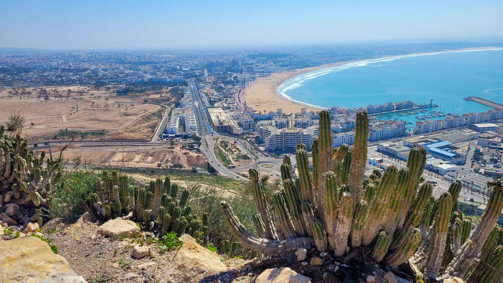 Winter sun over Agadir beach with palm trees