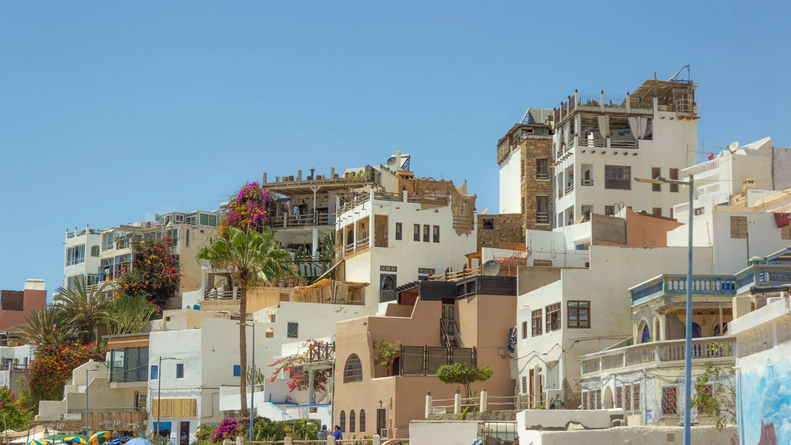 Colourful facades of a residential neighbourhood in Agadir under a blue sky